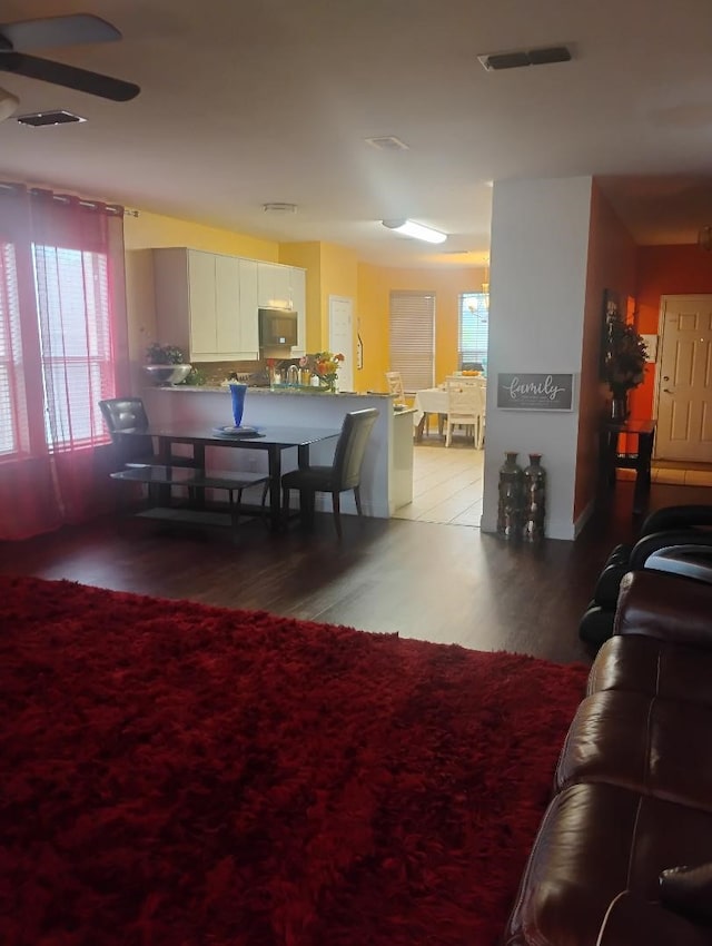 interior space featuring visible vents, wood finished floors, and ceiling fan