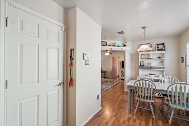 dining space featuring light hardwood / wood-style flooring and ceiling fan