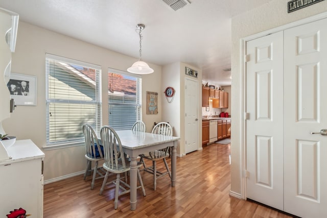 dining area featuring light wood-type flooring