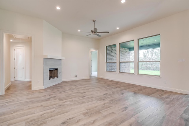 unfurnished living room featuring attic access, recessed lighting, and light wood-type flooring