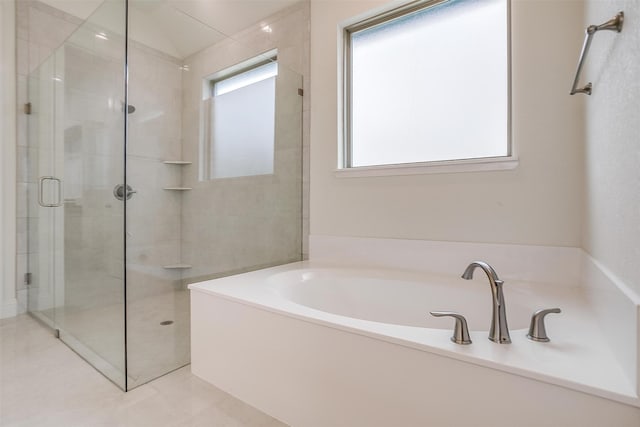 bathroom with shower with separate bathtub and tile patterned floors