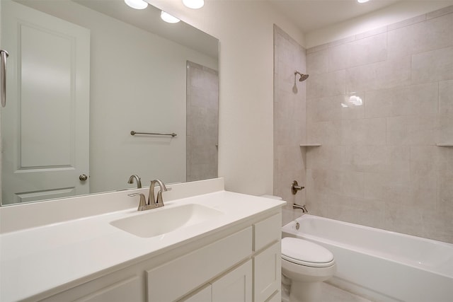 full bathroom with toilet, vanity, and tiled shower / bath