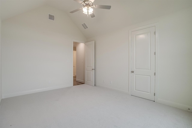 unfurnished bedroom with light colored carpet, lofted ceiling, and ceiling fan