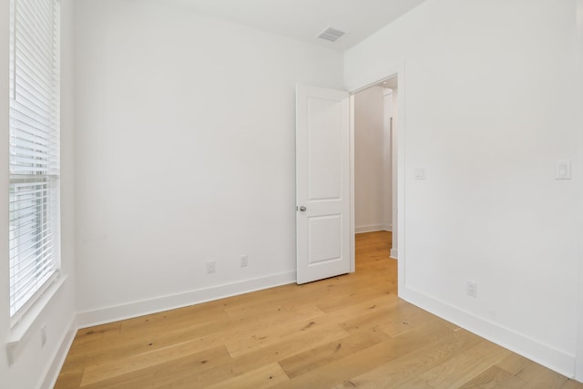 spare room with light hardwood / wood-style flooring