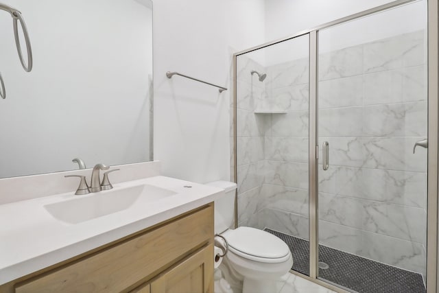 bathroom featuring walk in shower, vanity, and toilet