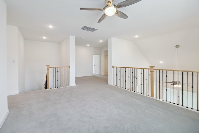 carpeted spare room featuring lofted ceiling and ceiling fan