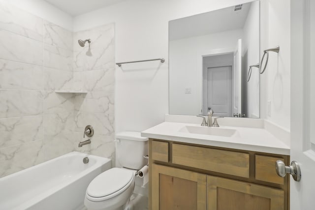 full bathroom featuring toilet, vanity, and tiled shower / bath