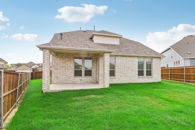 rear view of property with a patio and a yard