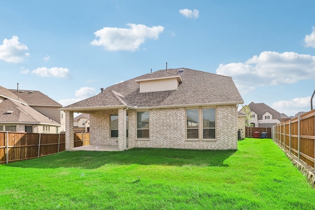 rear view of property featuring a patio area and a yard