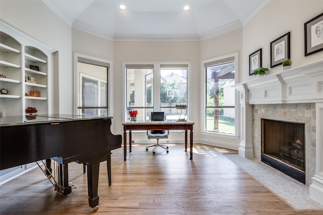 office featuring a healthy amount of sunlight, light hardwood / wood-style flooring, and ornamental molding