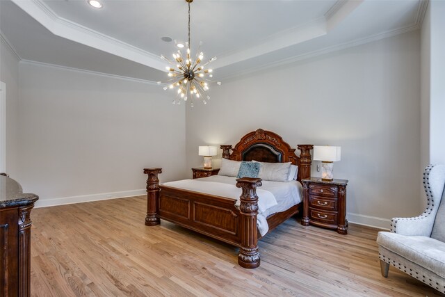 bedroom with light wood-type flooring, an inviting chandelier, a raised ceiling, and crown molding