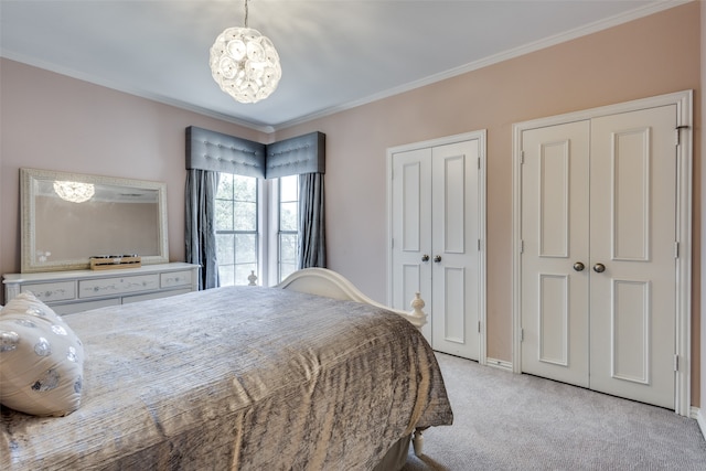 bedroom with crown molding, light carpet, and two closets