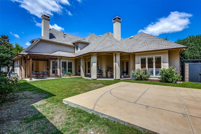 rear view of property featuring a shed, a lawn, and a patio area