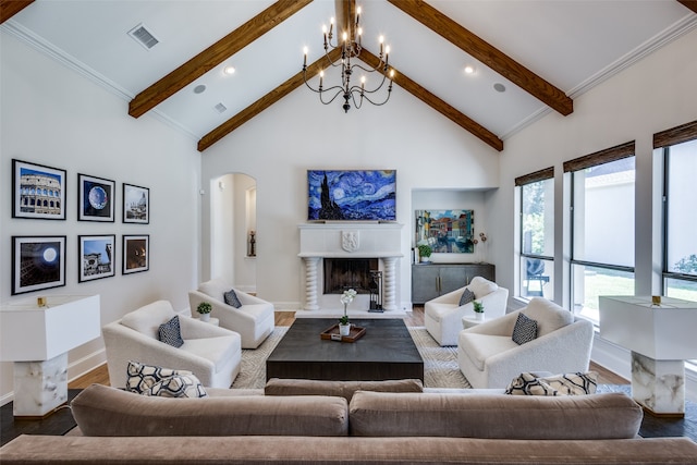 living room with hardwood / wood-style flooring, beamed ceiling, an inviting chandelier, and high vaulted ceiling