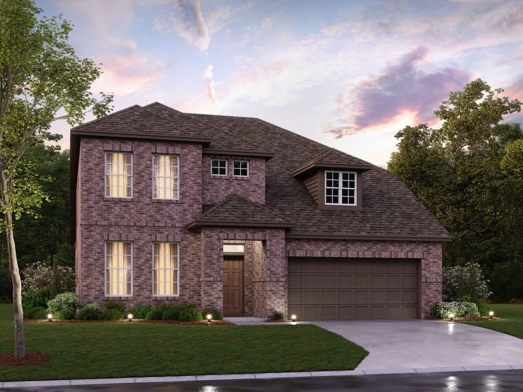 view of front of house with a garage and a lawn