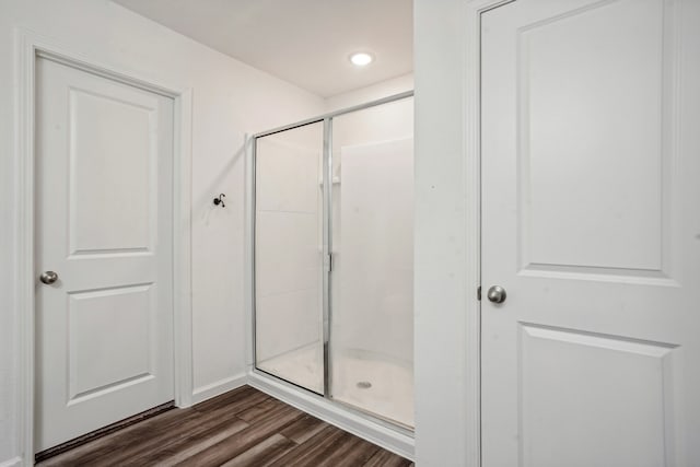 bathroom featuring an enclosed shower and hardwood / wood-style floors