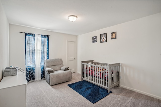 bedroom with a crib and carpet floors