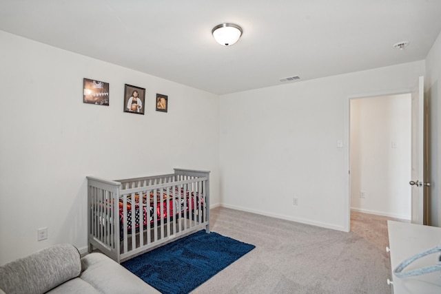 carpeted bedroom with a crib