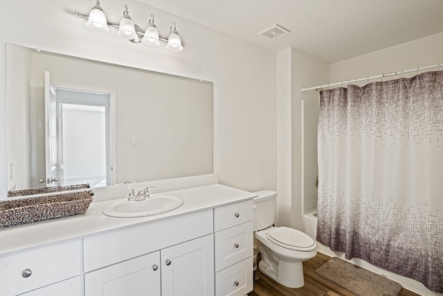 full bathroom featuring toilet, vanity, shower / bath combo with shower curtain, and hardwood / wood-style floors