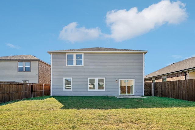 back of house featuring a yard