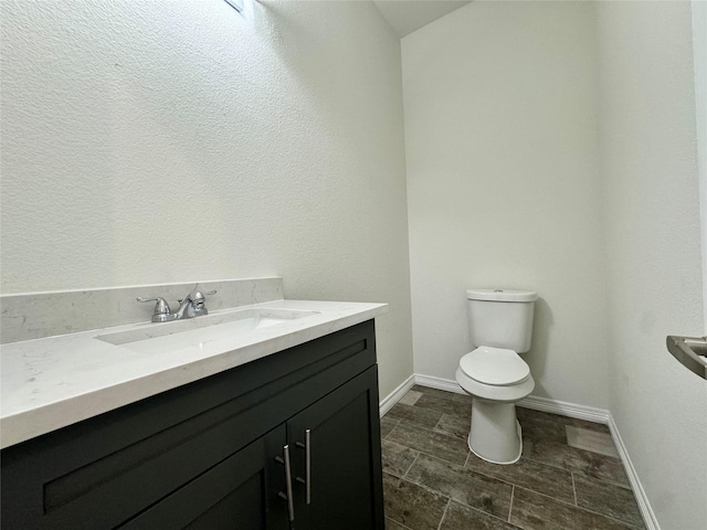 209 Smith St, Hillsboro, TX 76645 - half bath with vanity, toilet, and baseboards