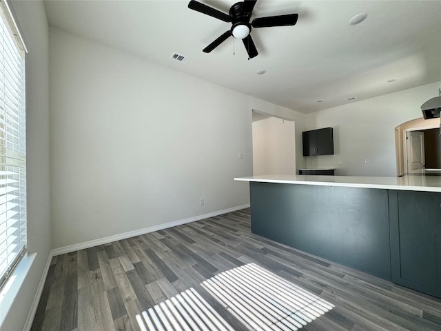 209 Smith St, Hillsboro, TX 76645 - unfurnished living room with wood finished floors, ceiling fan, and baseboards