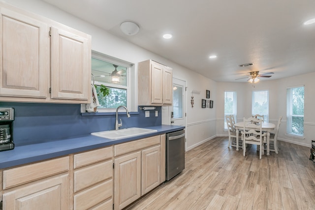 kitchen with dishwasher, light brown cabinetry, and sink