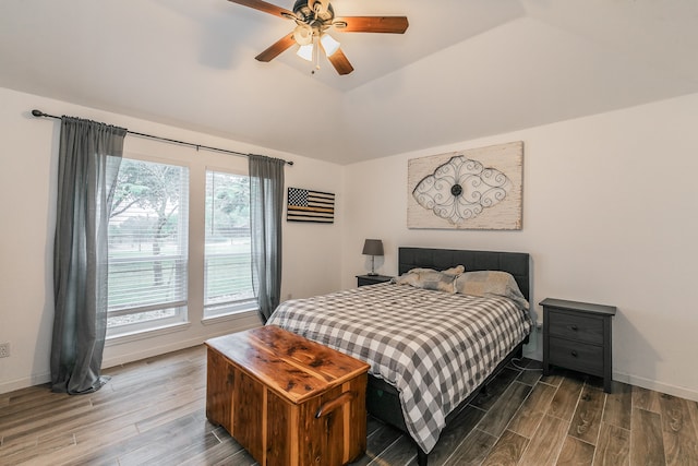 bedroom featuring hardwood / wood-style floors, ceiling fan, and lofted ceiling