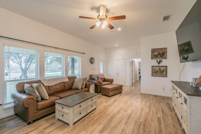 living room with ceiling fan and light wood-type flooring