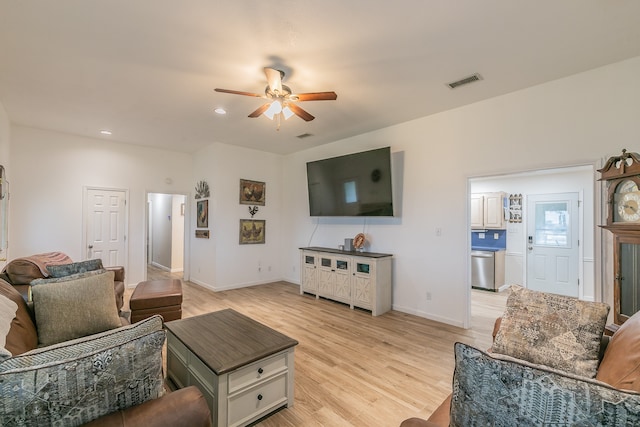 living room with ceiling fan and light wood-type flooring