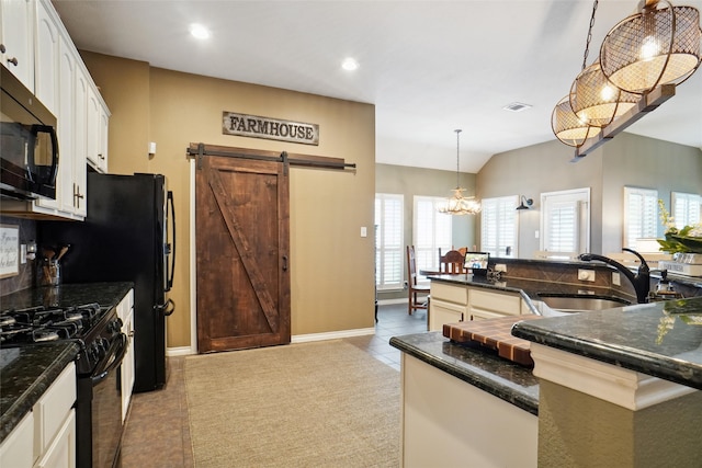 kitchen featuring plenty of natural light, black appliances, sink, and decorative light fixtures