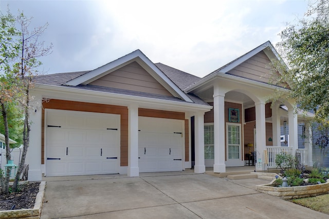 single story home featuring a garage and covered porch