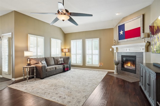 living room with dark wood-type flooring, plenty of natural light, and lofted ceiling