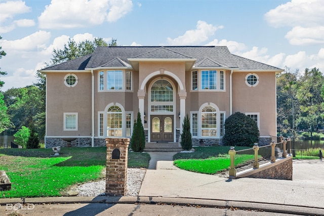 view of front facade featuring french doors and a front yard