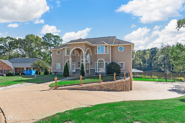 mediterranean / spanish home with a front lawn