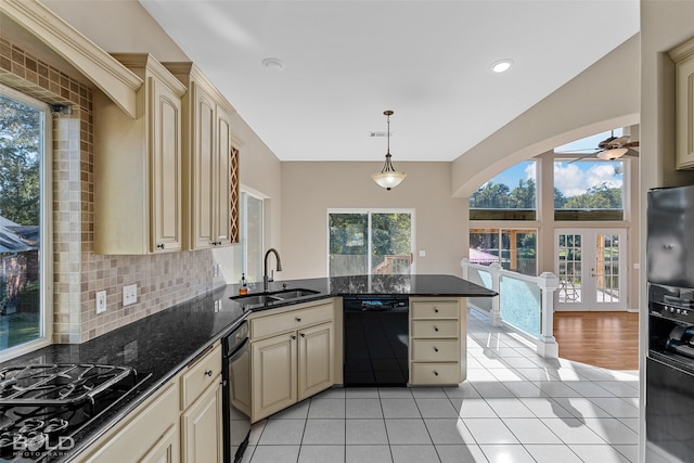 kitchen with kitchen peninsula, black appliances, sink, pendant lighting, and cream cabinetry