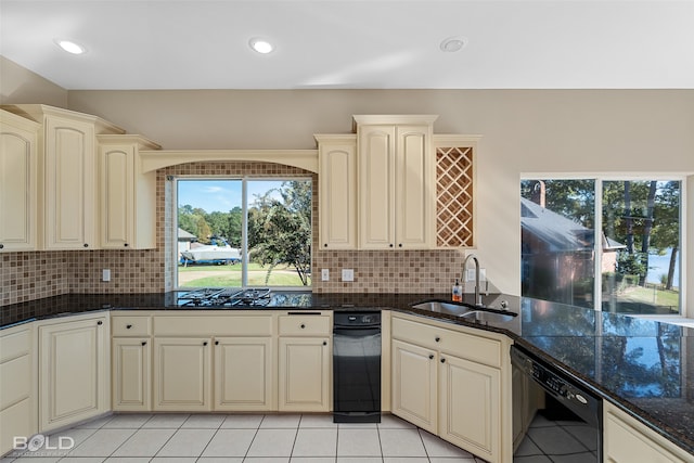 kitchen with cream cabinetry, sink, decorative backsplash, and dishwasher