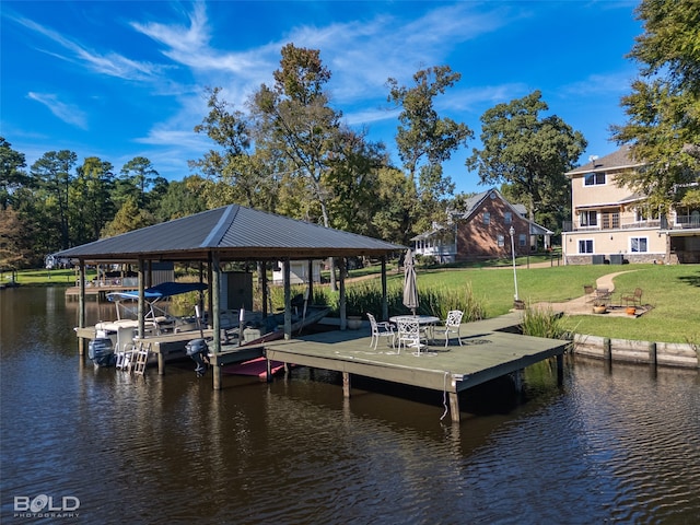 dock area with a yard and a water view