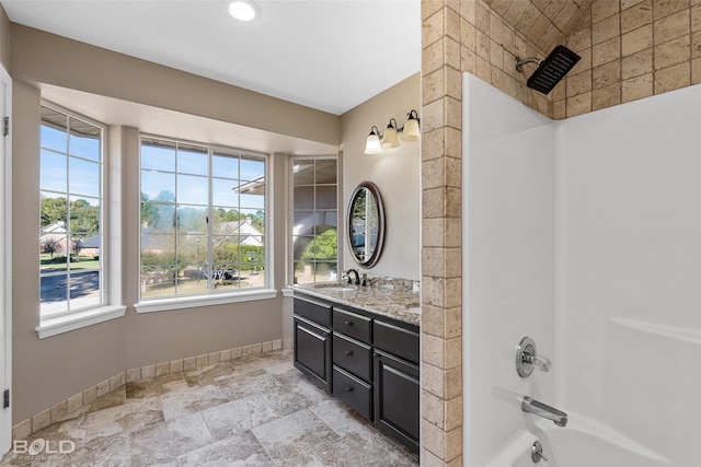 bathroom with vanity and shower / washtub combination