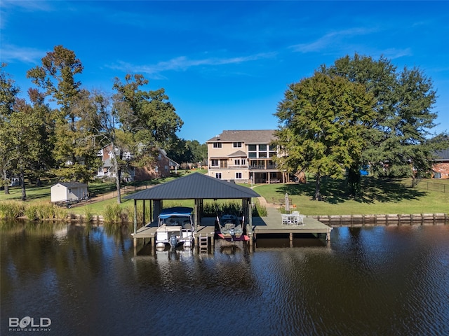 dock area with a water view and a lawn