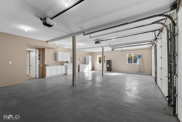 garage featuring a garage door opener and washer and clothes dryer