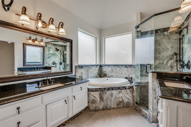 bathroom with vanity, tile patterned flooring, a textured ceiling, and separate shower and tub