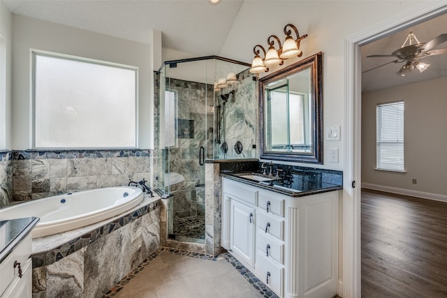 bathroom featuring hardwood / wood-style flooring, ceiling fan, independent shower and bath, vanity, and lofted ceiling