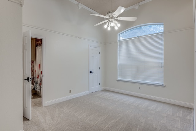 empty room featuring light carpet and ceiling fan