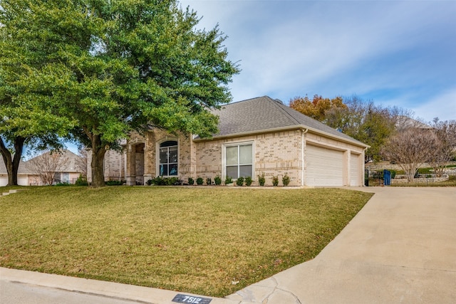 view of front of property with a garage and a front lawn