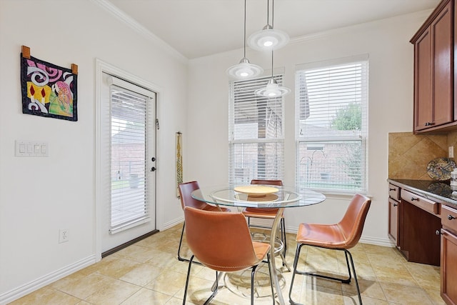 tiled dining space featuring plenty of natural light and crown molding