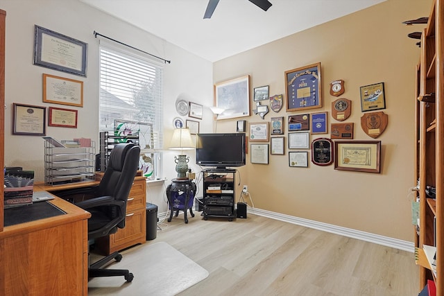 office with light hardwood / wood-style floors and ceiling fan