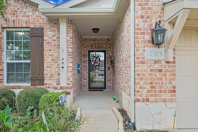 view of exterior entry featuring a garage