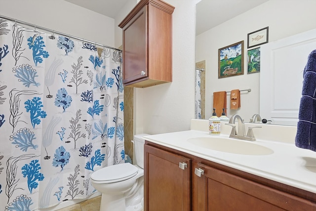 bathroom featuring tile patterned flooring, curtained shower, vanity, and toilet