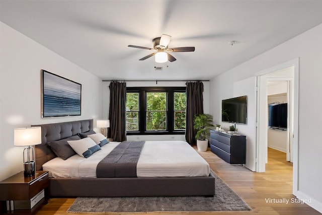 bedroom with ceiling fan and light hardwood / wood-style floors